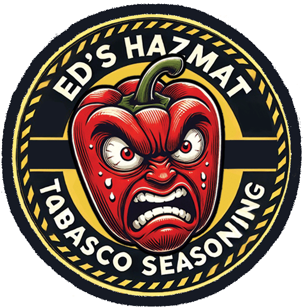 Circular label with an angry red pepper mascot, fierce eyes and teeth, yellow/black border, text reads: 'Ed's Hazmat Tabasco Seasoning'